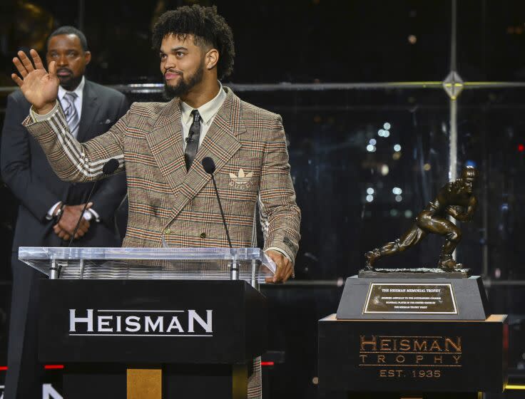 Southern California quarterback Caleb Williams waves after winning Heisman Trophy on Saturday.