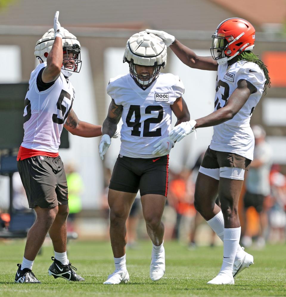 Cleveland Browns linebacker tony Fields II, center, is congratulated by teammates after picking off a pass during the NFL football team's football training camp in Berea on Wednesday.