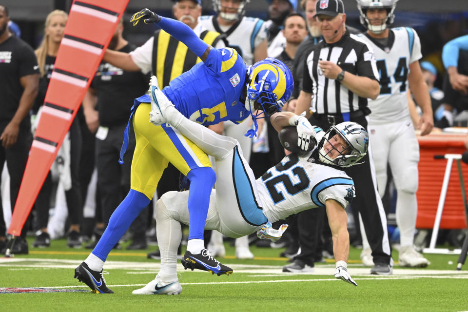 Los Angeles Rams cornerback Jalen Ramsey, top, tackles Carolina Panthers running back Christian McCaffrey (22) during the second half of an NFL football game Sunday, Oct. 16, 2022, in Inglewood, Calif. (AP Photo/Jayne Kamin-Oncea)