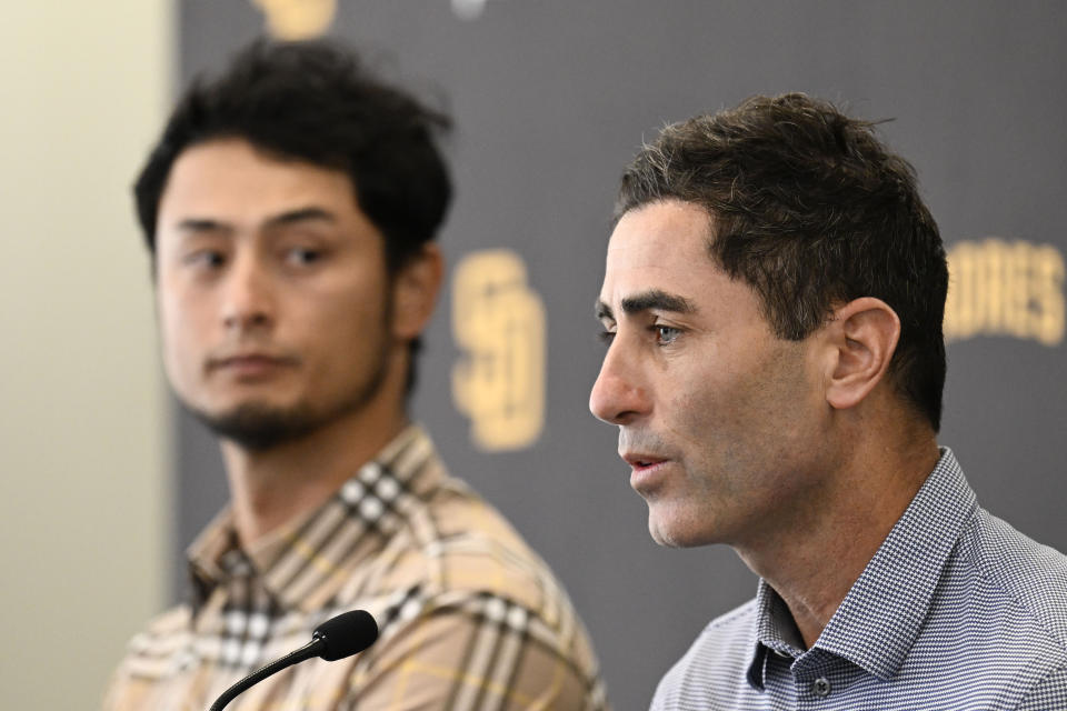 San Diego Padres general manager A.J. Preller, right, speaks as pitcher Yu Darvish looks on during a baseball news conference, Friday, Feb. 10, 2023, in San Diego. Darvish signed a new contract with the Padres that guarantees the pitcher an additional $90 million and will keep him with the club through the 2028 season. (AP Photo/Denis Poroy)