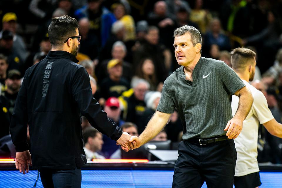 Iowa head coach Tom Brands, right, shakes hands with Nebraska associate head coach Bryan Snyder after a Big Ten Conference men's wrestling dual, Friday, Jan. 20, 2023, at Carver-Hawkeye Arena in Iowa City, Iowa. Iowa won, 34-6.