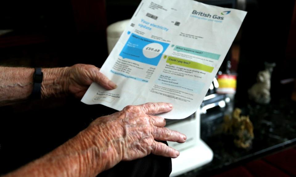 A generic stock photo of an elderly lady holding a British Gas bill at home in Liverpool (PA) (PA Archive)