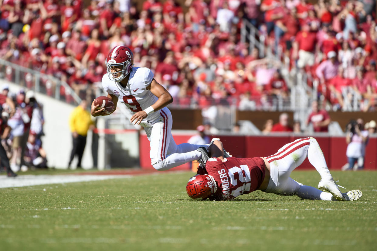 Alabama Crimson Tide quarterback Bryce Young (9) is chased down by Arkansas Razorbacks linebacker Drew Sanders (42) during Saturday's game at Razorback Stadium in Fayetteville, Arkansas. (Photo by Andy Altenburger/Icon Sportswire via Getty Images)