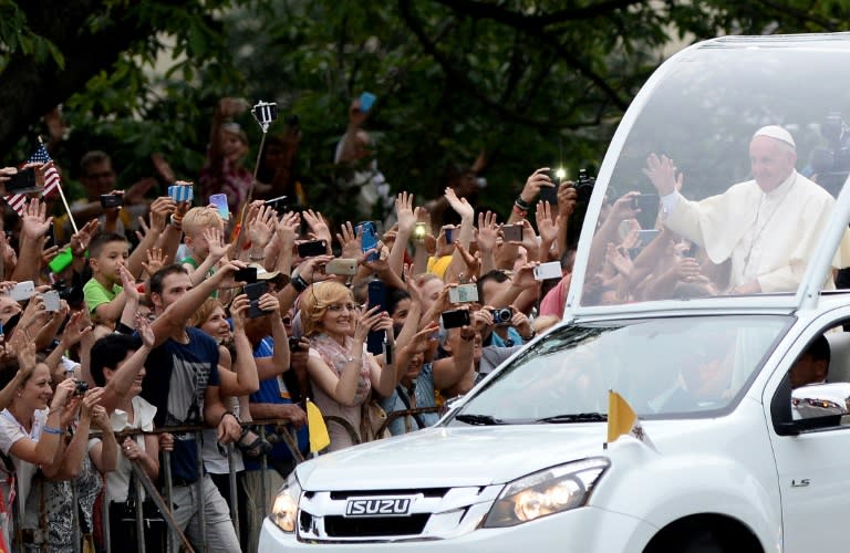 Pope Francis greets people from the popemobile in Krakow, on July 27, 2016