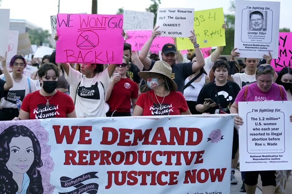 Thousands of protesters march around the Arizona Capitol after the Supreme Court decision to overturn the landmark Roe v. Wade abortion decision Friday, June 24, 2022, in Phoenix. The Supreme Court on Friday stripped away women’s constitutional protections for abortion, a fundamental and deeply personal change for Americans' lives after nearly a half-century under Roe v. Wade. The court’s overturning of the landmark court ruling is likely to lead to abortion bans in roughly half the states. (AP Photo/Ross D. Franklin)