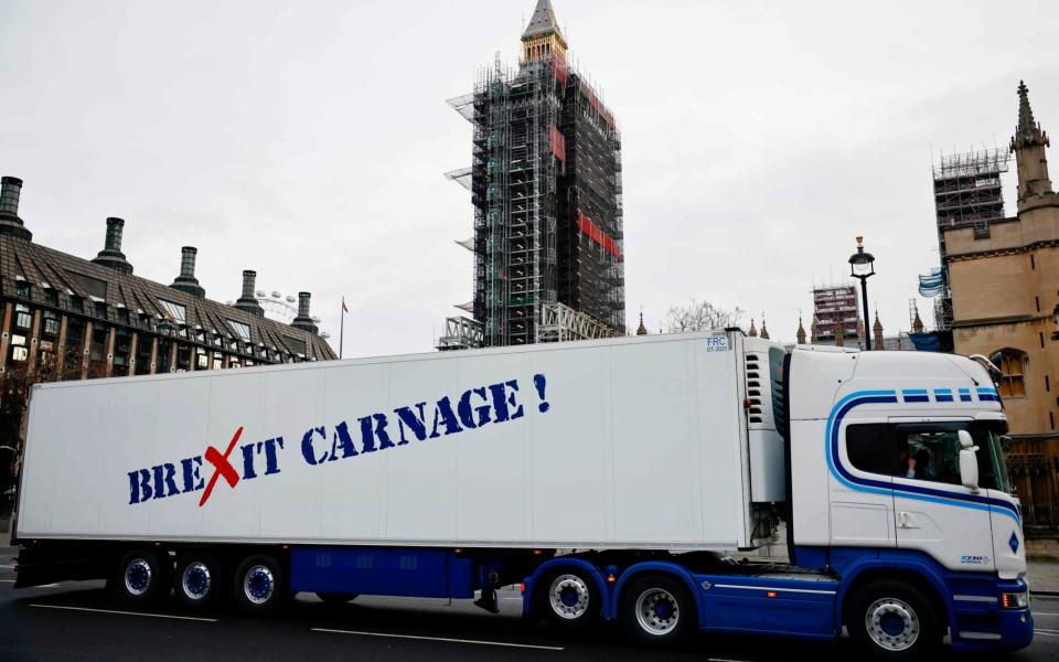 A truck drives past the Houses of Parliament with a message that reads "Brexit carnage!" in a protest action by Scottish fishermen against post-Brexit red tape - AFP