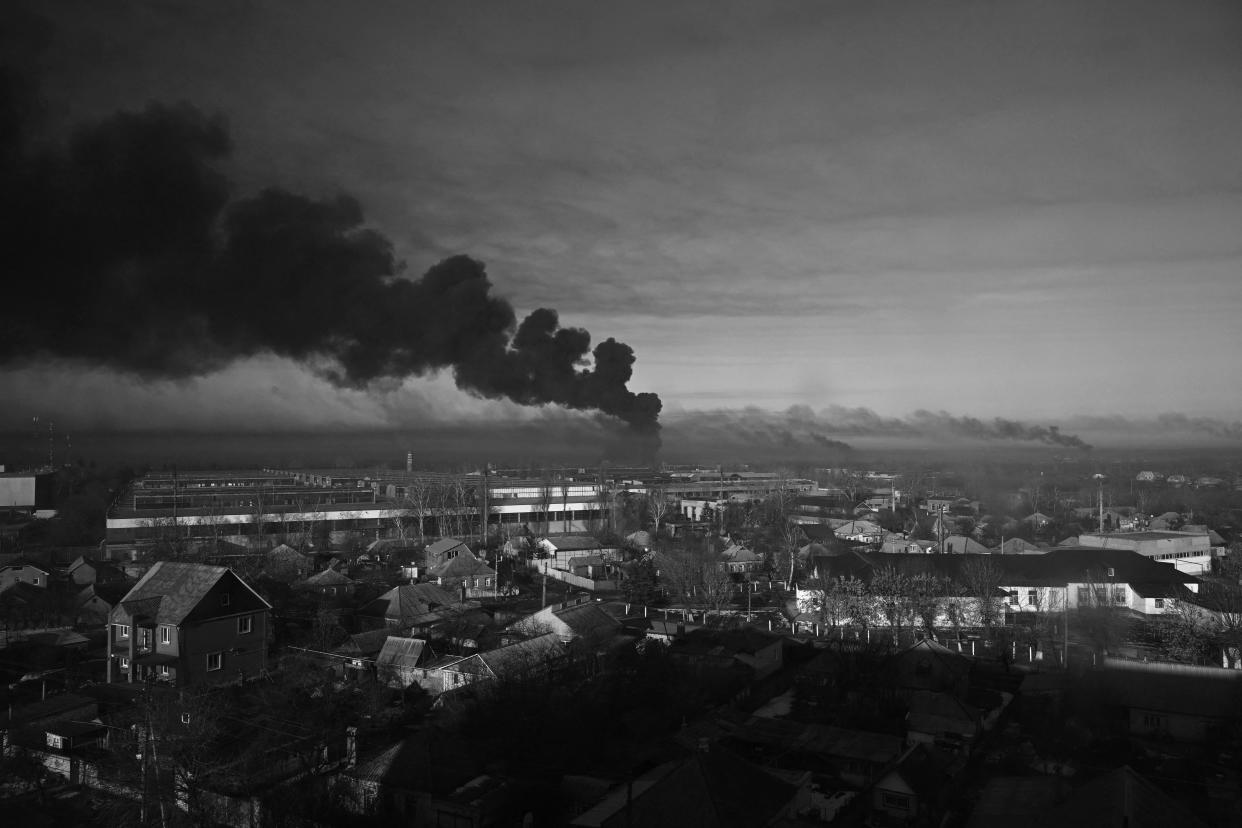 Black smoke rises from a military airport in Ukraine on the first day of the Russian invasion. 