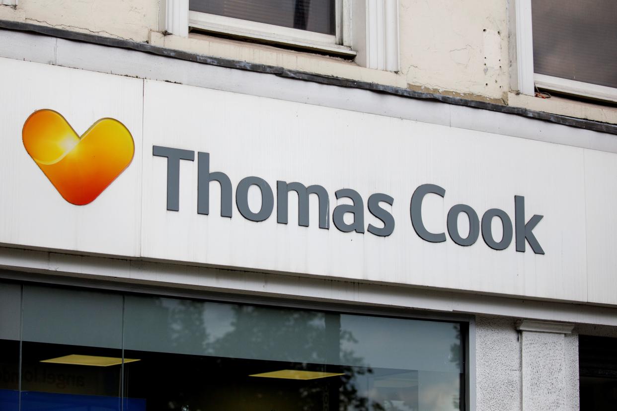 A sign is pictured above a branch of a Thomas Cook travel agent's shop in London on July 12, 2019. - China's Fosun Group is considering nearly a billion dollar rescue of embattled British tour operator Thomas Cook, the Hong Kong-listed conglomerate confirmed Friday. The Chinese company said in a stock market announcement that there are "ongoing advanced discussions" about a capital injection which would see a debt-for-equity swap at the British travel agency, which has struggled with its debt pile. (Photo by Tolga Akmen / various sources / AFP)        (Photo credit should read TOLGA AKMEN/AFP/Getty Images)