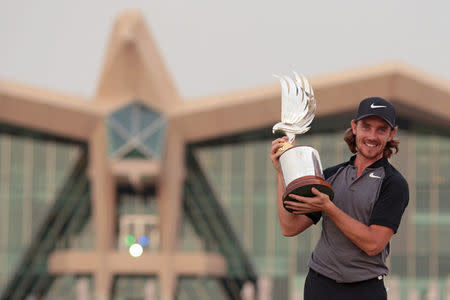 Golf - Abu Dhabi HSBC Golf Championship - Abu Dhabi, United Arab Emirates - 22/1/17 - Tommy Fleetwood of Britain poses with the trophy after winning. REUTERS/Stringer