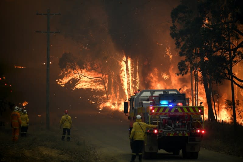 NSW Rural Fire Service crews fight a fire as it burns close to property on Wheelbarrow Ridge Road at Colo Heights, north west of Sydney