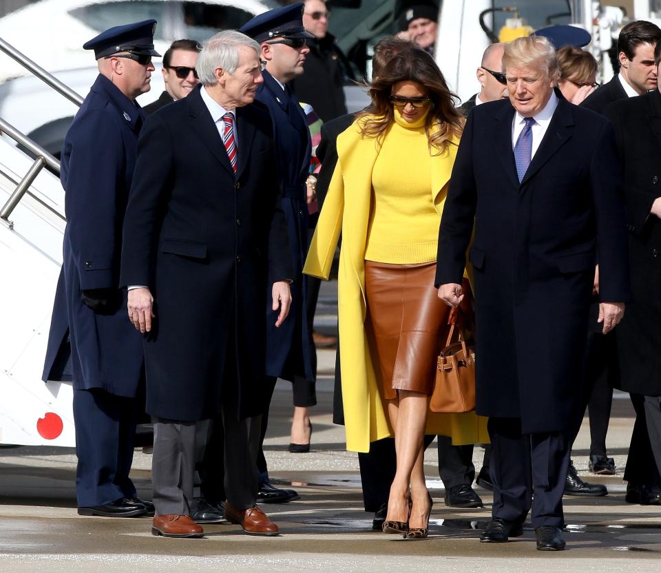 Senator Rob Portman, left, First Lady Melania Trump and President Donal at Lunken Airport Monday February 5, 2018.