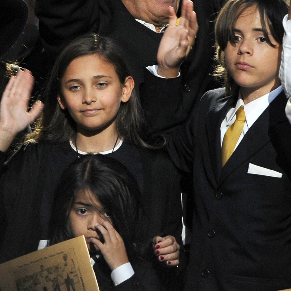 Paris (top left), Bigi (bottom left) and Prince wave the Michael Jackson public memorial service in Los Angeles in 2009