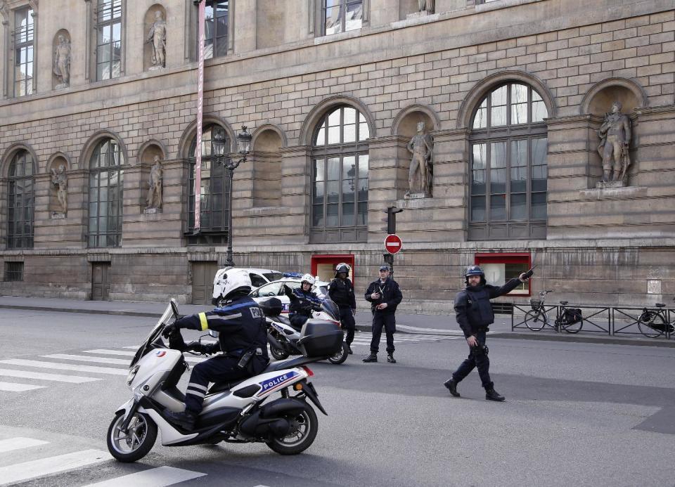 Police officers cordon off the area next to the Louvre museum in Paris,Friday, Feb. 3, 2017. Paris police say a soldier has opened fire outside the Louvre Museum after he was attacked by someone, and the area is being evacuated. (AP Photo/Thibault Camus)