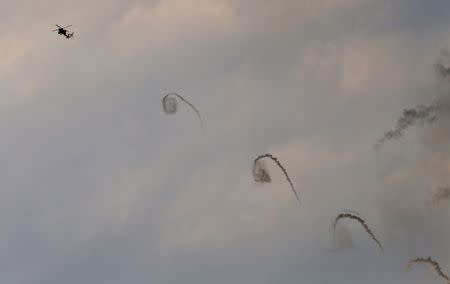 An Israeli Apache helicopter fires flares above Israel near the border with northern Gaza July 20, 2014. REUTERS/Baz Ratner