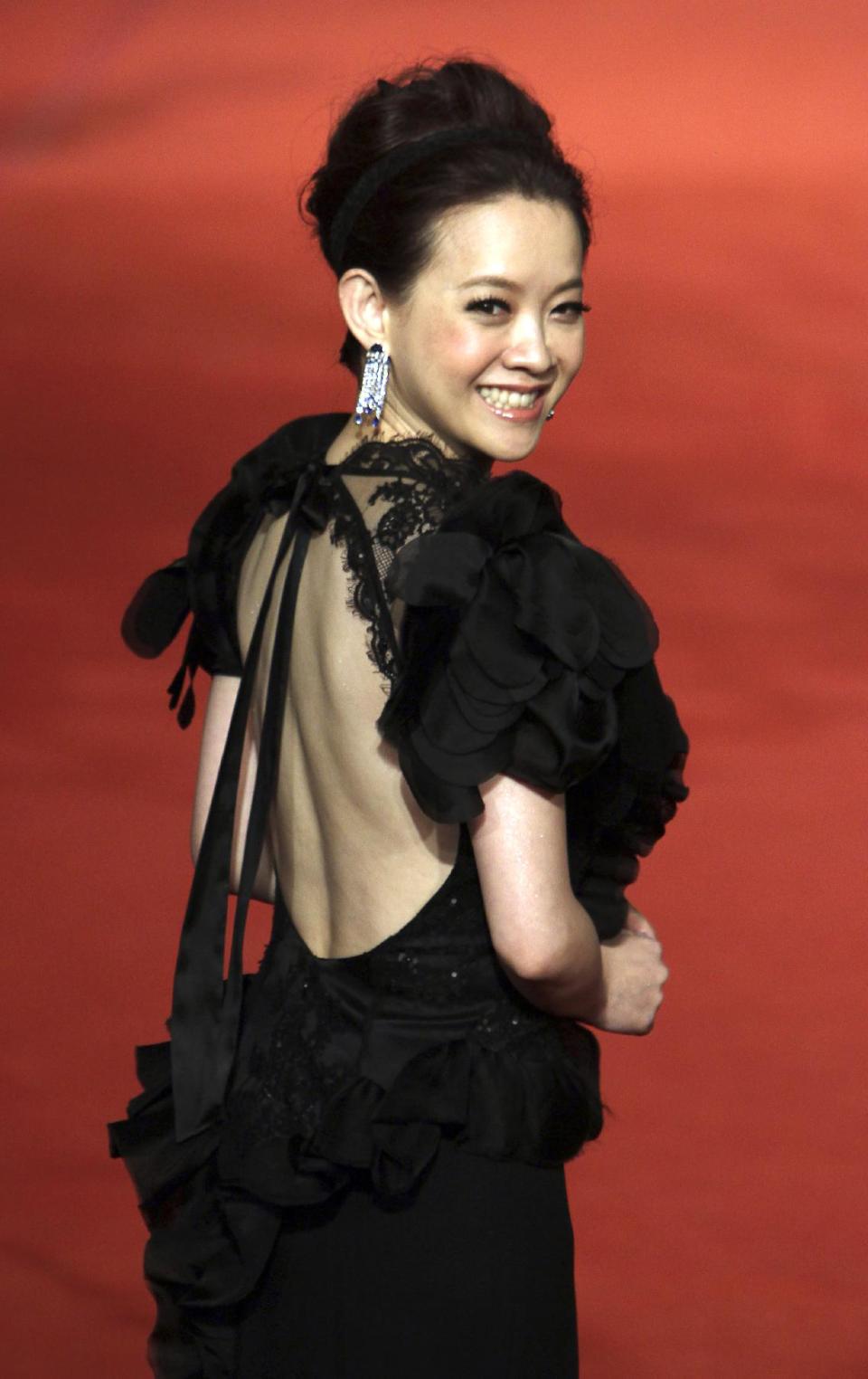 Hong Kong Actress BoWei Tsang smiles as she arrives at the 49th Golden Horse Awards at the Luodong Cultural Working House in Yilan County, Taiwan, Saturday, Nov. 24, 2012. Tsang is a host at this year's Golden Horse Awards -one of the Chinese-language film industry's biggest annual events.(AP Photo/Chiang Ying-ying)