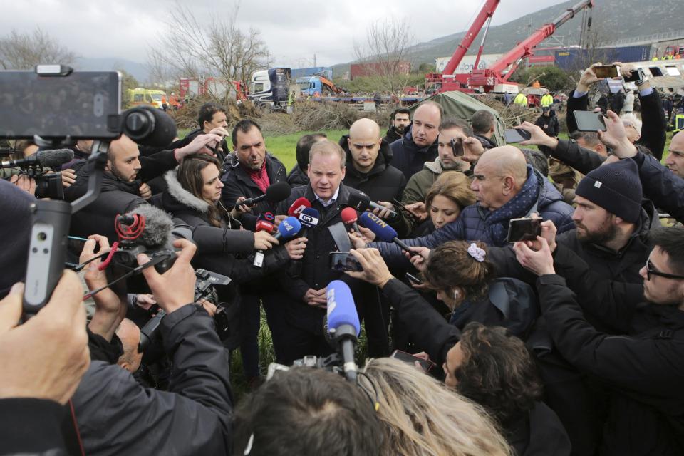 Transport Minister Kostas Karamanlis makes statements to the media during his visit at the location of a collision of the train in Tempe, about 376 kilometres (235 miles) north of Athens, near Larissa city, Greece, Wednesday, March 1, 2023. Karamanlis resigned Wednesday, saying he felt it was his "duty" to step down. A passenger train carrying hundreds of people, including many university students returning home from holiday, has collided at high speed with an oncoming freight train. (George Kidonas/InTime News via AP)