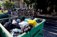 Lebanese riot policemen walk at the head of a rally with demonstrators heading from the Ministry of Interior to Beirut's Martyrs Square to protest against a political class seen as corrupt and incapable of providing basic services on August 29, 2015