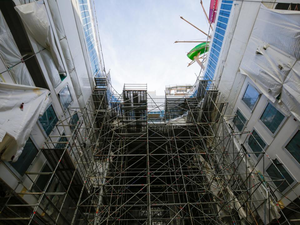 An outdoor space under construction with scaffolding on Royal Caribbean's Icon of the Seas