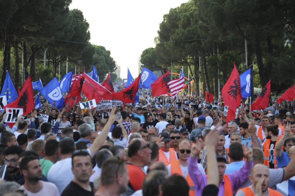 Demonstrators gather during an anti-government demonstration in Tirana, Albania, Saturday, June 8, 2019. Thousands of Albanian opposition supporters are gathering in an anti-government protest while the United States and the European Union caution their leaders to disavow violence and sit in a dialogue to overcome the political crisis. (AP Photo/Hektor Pustina)