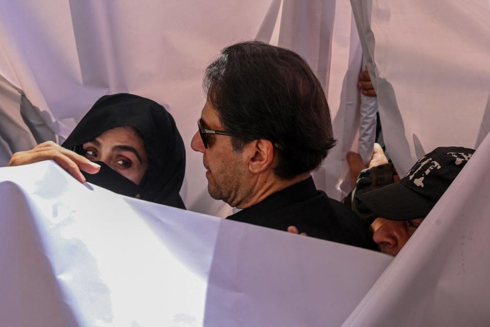 Former Pakistan Prime Minister Imran Khan (C) with his wife Bushra Bibi (L) arrive to appear at a high court in Lahore in May 2023 (AFP via Getty Images)