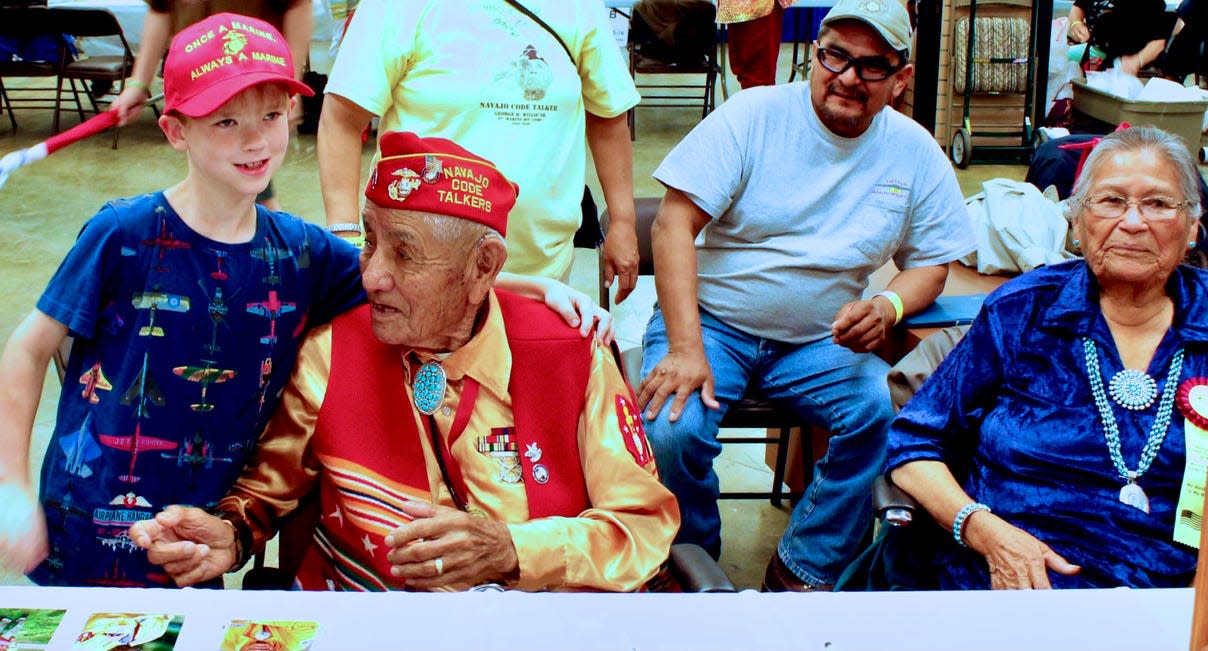 A young boy shows respect and appreciation to George Willie Sr., Navajo Code Talker, at the Trail of Honor in 2015. Willie is from Leupp, Arizona, and was born in a small Navajo community near a sawmill.