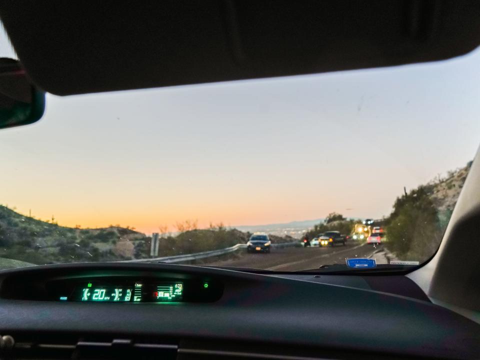 A view of a sunset from inside a car