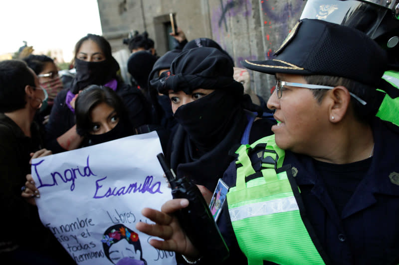 People take part in a protest against gender-based violence in downtown of Mexico City