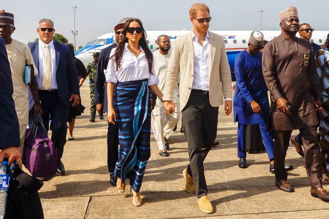 <p>Andrew Esiebo/Getty</p> Meghan, The Duchess of Sussex and Prince Harry arrive at Lagos airport on May 12, 2024