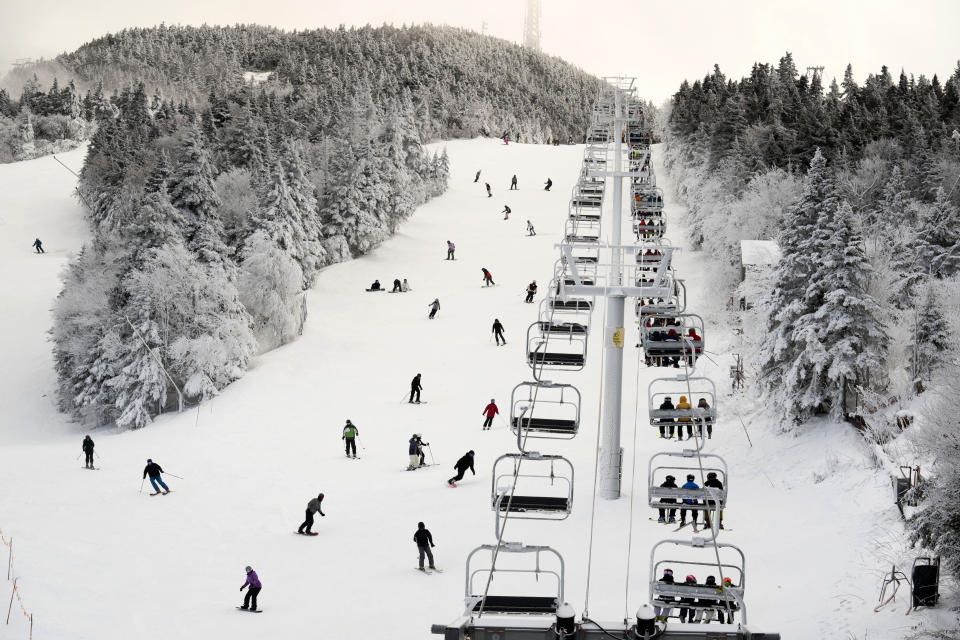 FILE - Thanksgiving holiday skiers descend near the North Ridge Quad chairlift, Nov. 24, 2023, at Killington Ski Resort in Killington, Vt. A new study says U.S. ski areas lost about $5 billion from 2000 to 2019 as a result of human-caused climate change. (AP Photo/Robert F. Bukaty, File)