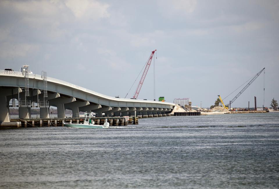 Work continues on the Sanibel Causeway on Thursday, Sept 7, 2023. Crews are paving new lanes so that the existing roadway can be raised. Cranes and backhoes are working in other areas to restore and improve the roadway nearly one year after Hurricane Ian.