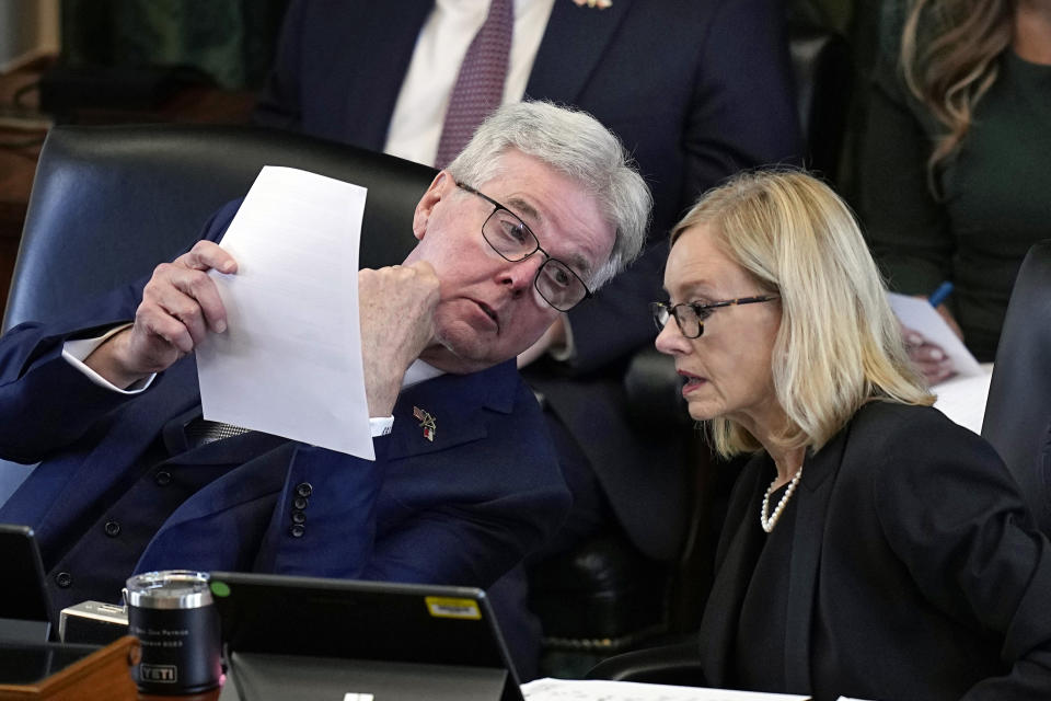 Texas Lt. Gov. Dan Patrick, left, talks with legal counsel Lana Myers, right, during the impeachment trial for Texas Attorney General Ken Paxton in the Senate Chamber at the Texas Capitol, Tuesday, Sept. 5, 2023, in Austin, Texas. (AP Photo/Eric Gay)