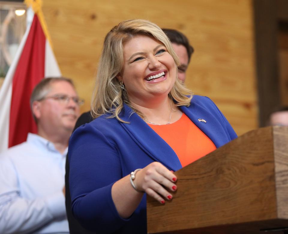 Congresswoman Kat Cammack smiles as she delivers comments during an anti-vaccine mandate rally held at Clark Plantation in Newberry, Fla. Sept. 13, 2021. Gov. Ron DeSantis was in town during the morning to congratulate the University of Florida for reaching Top 5 status, and then spoke to a couple of hundred supporters about vaccine mandates and lambasted the cityof Gainesville for threatening to fire city employees who did not get the Covid-19 vaccine.