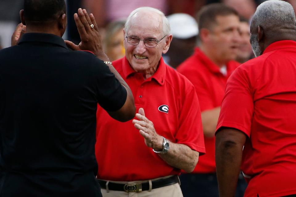 Former Georgia coach Vince Dooley on the field while UGA honored the first five Black Bulldog football players before the start of an NCAA college football game between South Carolina and Georgia in Athens, Ga., on Sept. 18, 2021.