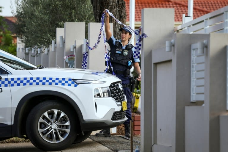 A police officer lifts tape to let a car into the Christ the Good Shepherd Church in western Sydney, scene of a live-streamed stabbing earlier in the week (DAVID GRAY)