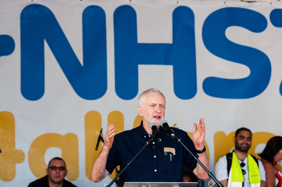 LONDON, UNITED KINGDOM - JUNE 30: Labour Party leader Jeremy Corbyn addresses a rally outside Downing Street in central London celebrating the 70th anniversary of the National Health Service. Thousands of protesters called for an end to austerity policies which lead to underfunding and staff shortages in the NHS, and demand that it remains publicly owned and accessible to everyone. June 30, 2018 in London, England. (Photo credit should read Wiktor Szymanowicz / Barcroft Media via Getty Images)