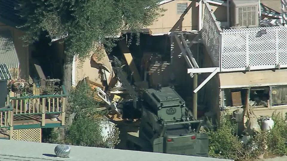 PHOTO: Police used an armored vehicle with a hydraulic battering ram to tear down a home on Keissel Road as they searched for missing couple, Stephanie Menard, 73, and her husband, Daniel, 79 in Redlands, Calif. (KABC)