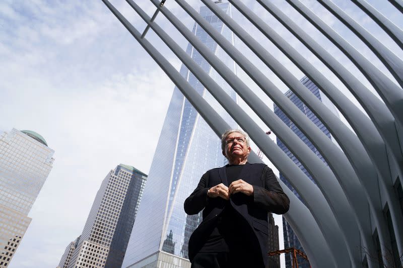 Architect Daniel Libeskind does up his jacket as he poses for a portrait at the 9/11 Memorial site