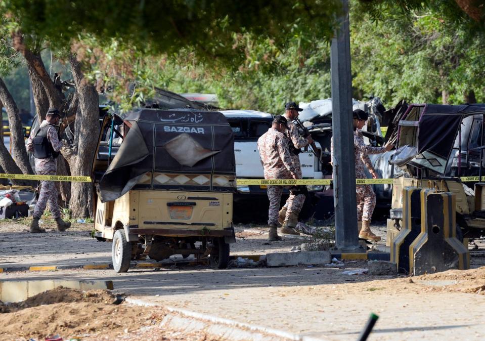 Security officials work at the scene of an explosion that caused injuries and destroyed vehicles outside the airport in Karachi, Pakistan, Monday, Oct. 7, 2024. (Copyright 2024 The Associated Press. All rights reserved.)