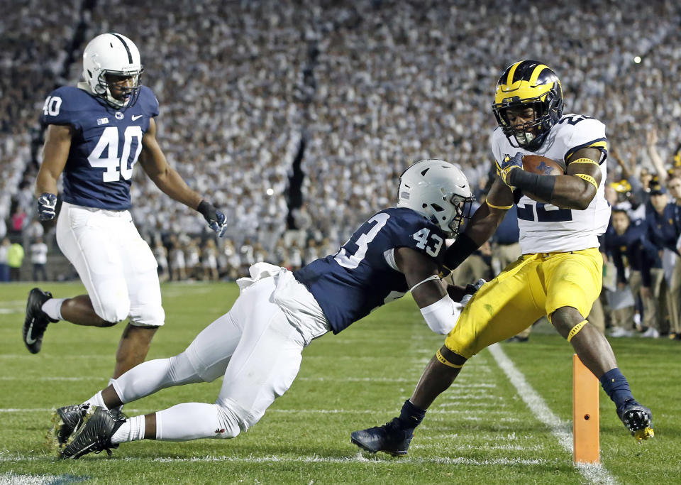 Penn State’s Manny Bowen (43) hits Michigan’s Karan Higdon (22) as he scores a touchdown during the first half of an NCAA college football game in State College, Pa., Saturday, Oct. 21, 2017. (AP Photo/Chris Knight)