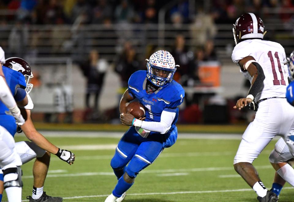 Coleman quarterback Jadin Jackson tries to scramble past the Hawley defense during Friday's Region I-2A Division I semifinals game.