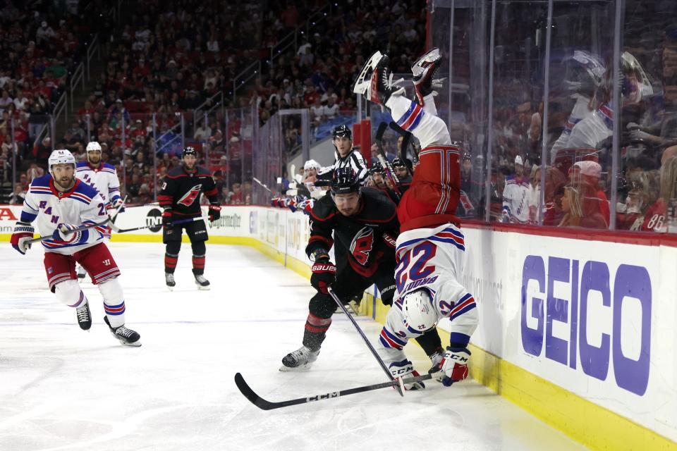 RALEIGH, NORTH CAROLINA - MAY 11: Dmitry Orlov #7 of the Carolina Hurricanes hits Jonny Brodzinski #22 of the New York Rangers during the third period in Game Four of the Second Round of the 2024 Stanley Cup Playoffs at PNC Arena on May 11, 2024 in Raleigh, North Carolina.