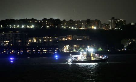 An FDNY fire department boat searches the Hudson River for the wreckage of a vintage P-47 Thunderbolt airplane that crashed in the river in New York City, New York, U.S. May 27, 2016. REUTERS/Brendan McDermid