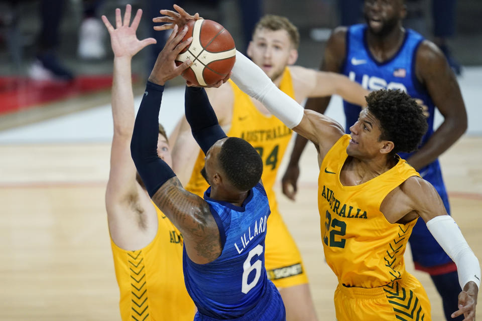 Australia's Matisse Thybulle knocks the ball away from United States' Damian Lillard during an exhibition basketball game Monday, July 12, 2021, in Las Vegas. (AP Photo/John Locher)