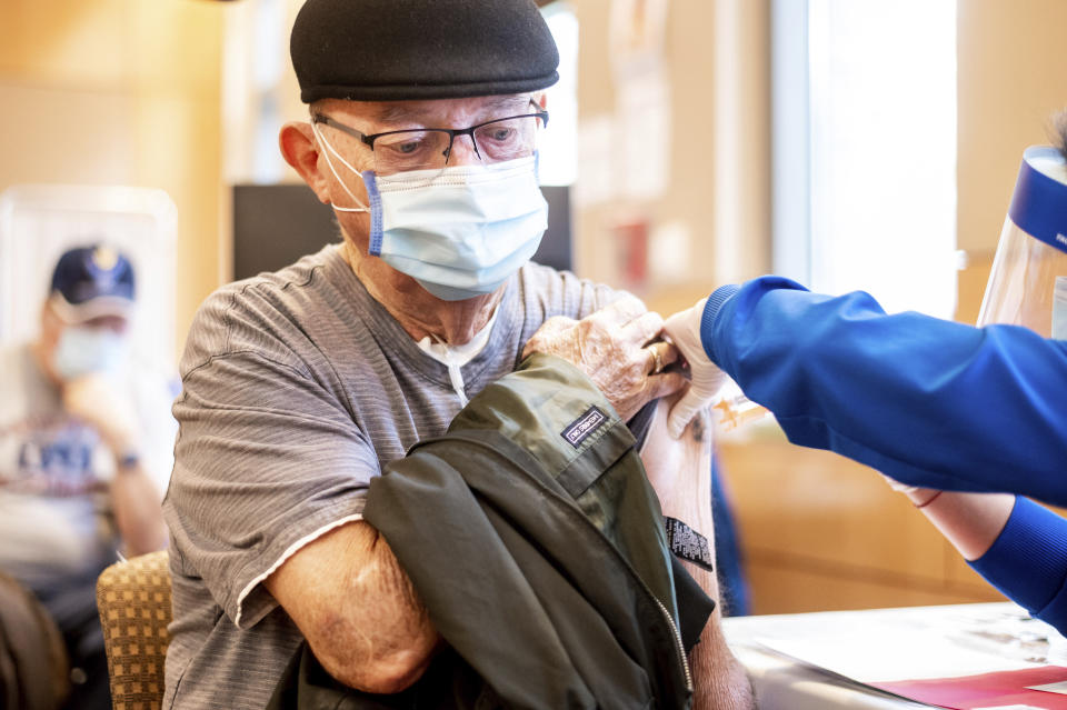 Jim Clark, 86, receives a first dose of Pfizer-BioNTech COVID-19 vaccine from UC Davis Health on Tuesday, Jan. 12, 2021, in Sacramento, Calif. (AP Photo/Noah Berger, Pool)