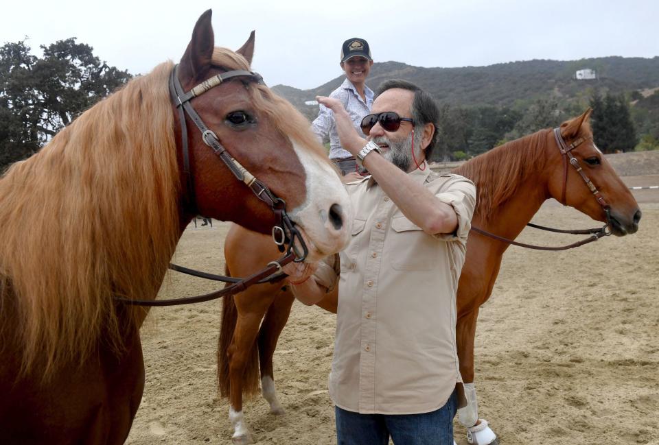 Lou Gonda, El Campeon Farms owner, pets Truffles as trainer Abby Followwill watches with horse Chacha on Friday, Oct. 14, 2022. El Campeon Farms in Hidden Valley is home to the Santa Cruz Island horses, which were rescued from Santa Cruz Island after it was purchased by the National Park Service. The staff have worked to maintain the genetically unique breed.