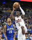 Cleveland Cavaliers guard Caris LeVert (3) shoots in front of Orlando Magic guard Markelle Fultz during the first half of Game 3 of an NBA basketball first-round playoff series Thursday, April 25, 2024, in Orlando, Fla. (AP Photo/John Raoux)