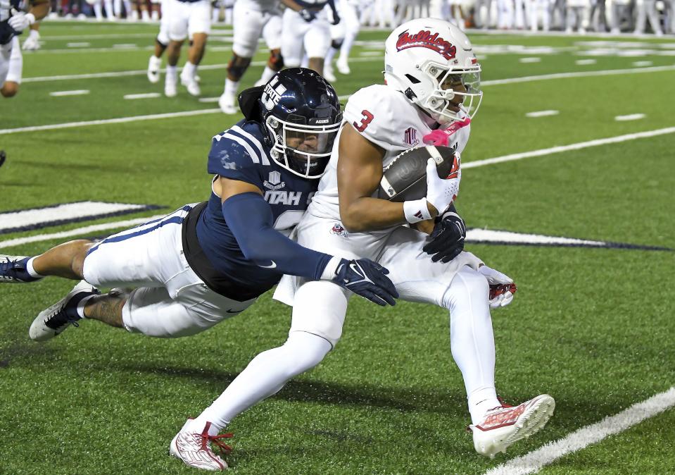 Fresno State wide receiver Erik Brooks (3) tries to get away from Utah State linebacker MJ Tafisi Jr. (2) during the first half of an NCAA college football game Friday, Oct. 13, 2023, in Logan, Utah. | Eli Lucero, The Herald Journal via Associated Press