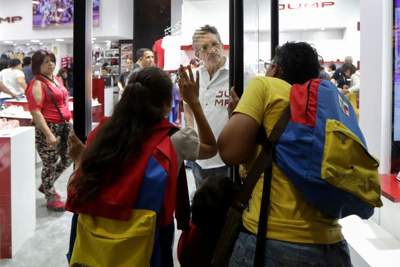 People talk with a store seller at a mall during the Black Friday sales in Caracas, Venezuela November 29, 2019. REUTERS/Manaure Quintero