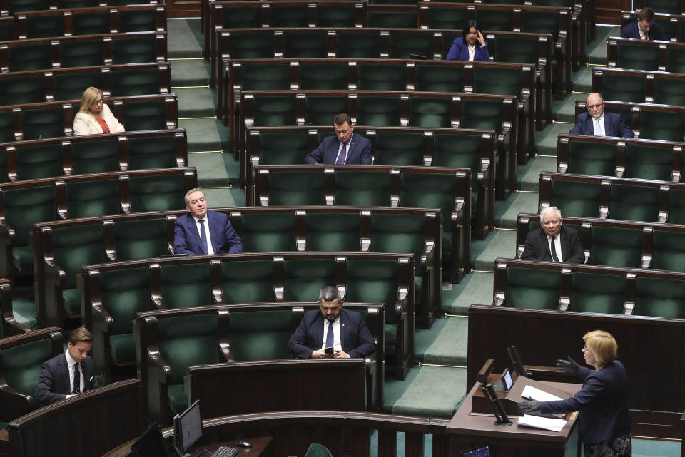 Jaroslaw Kaczynski, leader of the conservative ruling party Law and Justice, second row right, takes part in a parliamentary session in Warsaw, Poland, Friday, April 3, 2020. Uncertainty deepened in Poland on Friday over whether the country will move forward with a presidential election scheduled for May despite the coronavirus pandemic. Kaczynski had hoped to move forward with the vote despite the epidemic by having a postal election, but the head of a faction in his coalition is opposed and wants the elections postponed by two years.(AP Photo/Czarek Sokolowski)