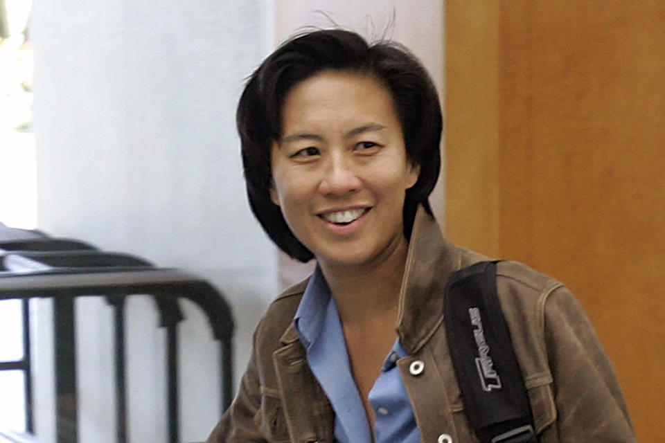 FILE - In this Nov. 5, 2007, file photo, then-Los Angeles Dodgers assistant general manager Kim Ng walks through the hotel lobby during the first day of the Major League Baseball annual general managers meetings in Orlando, Fla. Ng became the highest-ranking woman in baseball operations in the major leagues when the Miami Marlins hired her as general manager in 2020. (AP Photo/John Raoux, File)